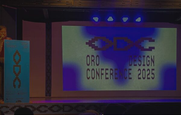 A female speaker delivers the opening remarks at the Oro Design Conference 2025 in Cagayan de Oro, with the event logo projected on stage.