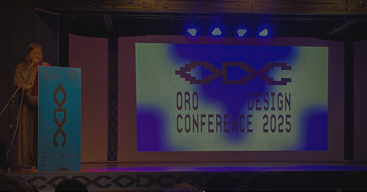 A female speaker delivers the opening remarks at the Oro Design Conference 2025 in Cagayan de Oro, with the event logo projected on stage.