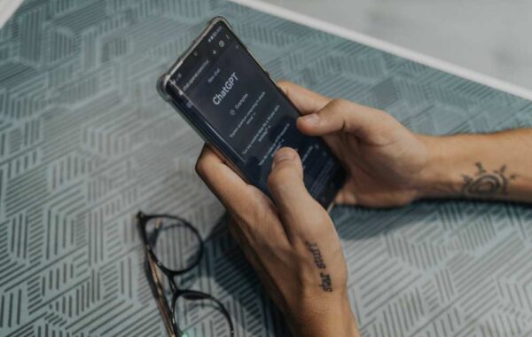 Hands holding a phone with ChatGPT open, reflecting how AI is changing online search habits.