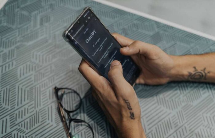 Hands holding a phone with ChatGPT open, reflecting how AI is changing online search habits.