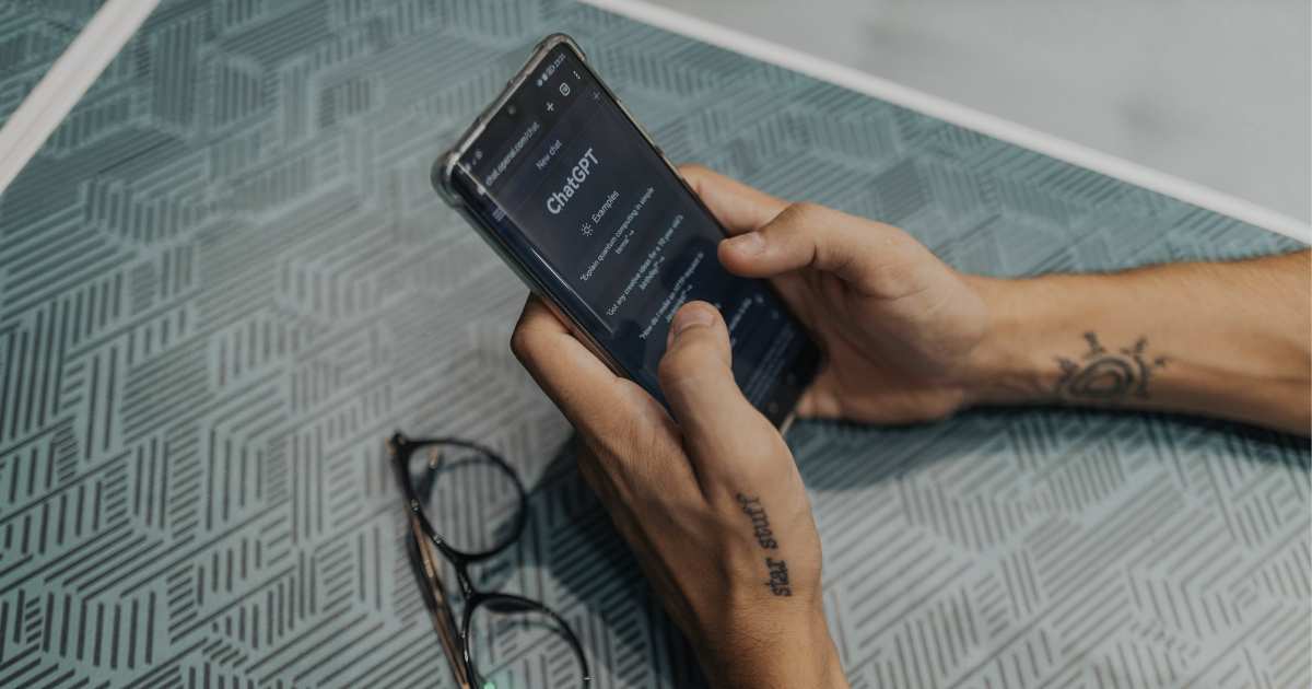 Hands holding a phone with ChatGPT open, reflecting how AI is changing online search habits.